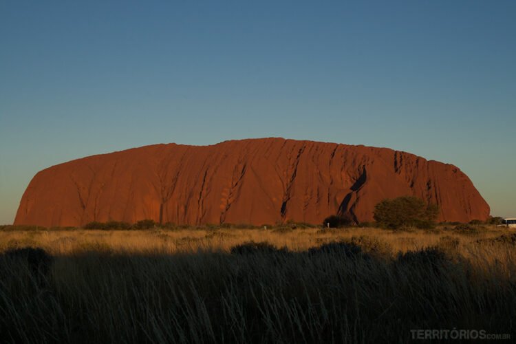 Sombra se aproxima de Uluru no final da tarde